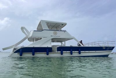Punta Cana Shared Party Boat Booze Cruise and Snorkeling - On-board party boat vibes: the slide, the music, and the open-bar rules